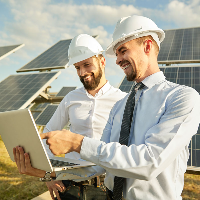 Men discussing the systems and processes of a solar farm
