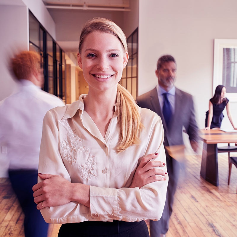 Woman standing in office of a busy law firm